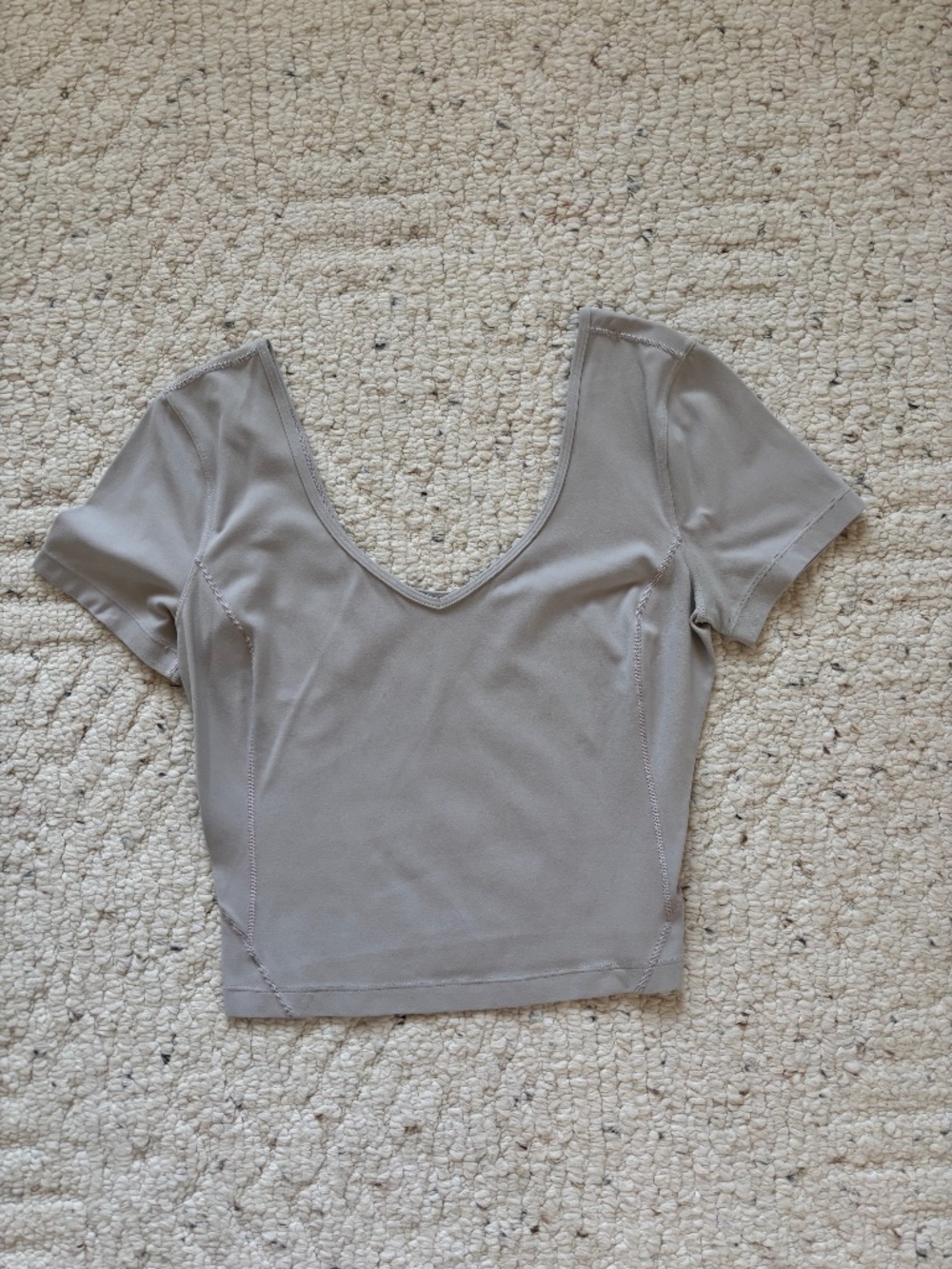 Woman’s Lululemon short-sleeve athletic top with wide scoop neckline and fit